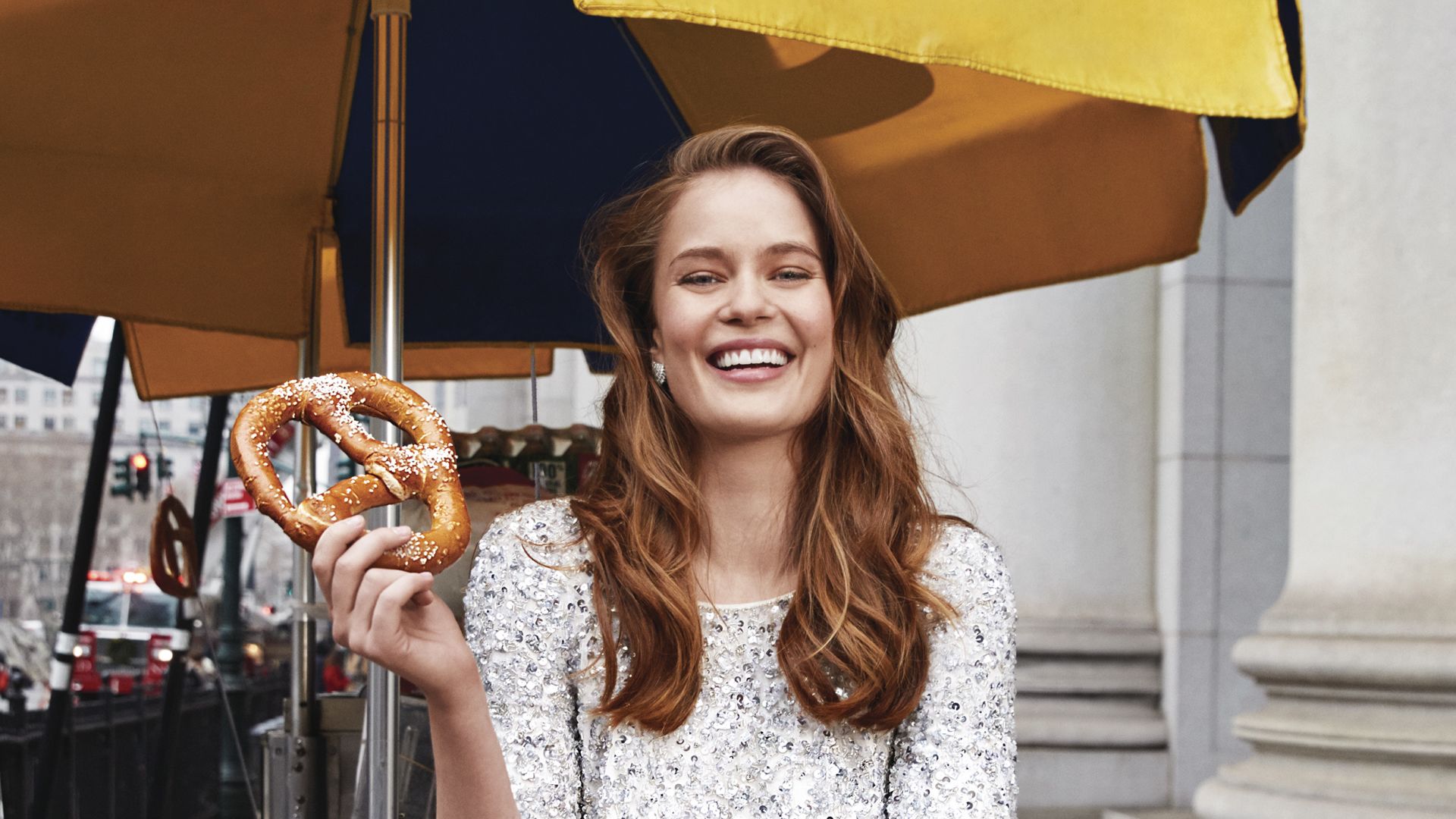 A Woman Holding An Umbrella And A Donut